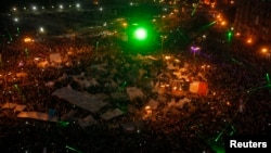 Laser lights are seen as anti-Morsi protesters gather in Cairo's Tahrir Square, July 3, 2013. 