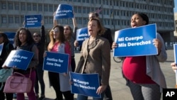 Activists with Planned Parenthood demonstrate in support of a pregnant 17-year-old being held in a Texas facility for unaccompanied immigrant children to obtain an abortion, outside of the Department of Health and Human Services in Washington, Oct. 20, 2017.