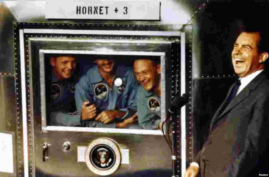 Apollo XI Astronauts Neil Armstrong (L), Michael Collins (C), and Buzz Aldrin laugh with President Richard Nixon aboard the USS Hornet, courtesy Richard Nixon Foundation, July 24, 1969.