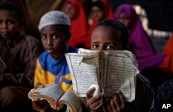 Somali refugee boys recite the Koran at a Madrassa, or Islamic religious school, at Dadaab refugee camp, Dec. 19, 2017.