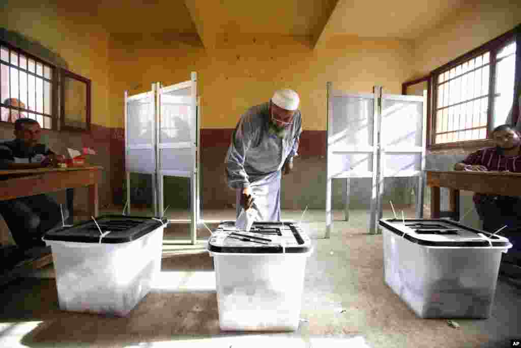 An Egyptian man cast his vote inside a polling station, in Old Cairo, Egypt, Wednesday, May 23, 2012. More than 15 months after autocratic leader Hosni Mubarak's ouster, Egyptians streamed to polling stations Wednesday to freely choose a president for the