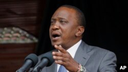 FILE - Kenyan President Uhuru Kenyatta delivers a speech at the Nyayo Nationa Stadium in Nairobi, Kenya. Kenyatta faces crimes against humanity in violence following 2007 election.