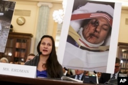 FILE - Stephanie Erdman, an Air Force 1st lieutenant, describes her experience when she was injured by metal fragments from a defective airbag made by Takata of Japan as she testifies on Capitol Hill in Washington on Nov. 20, 2014.