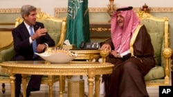 U.S. Secretary of State John Kerry, left, talks with Saudi Foreign Minister Prince Saud Al-Faisal bin Abdulaziz al-Saud, after Kerry arrived in Riyadh, Saudi Arabia, Nov. 3, 2013. 