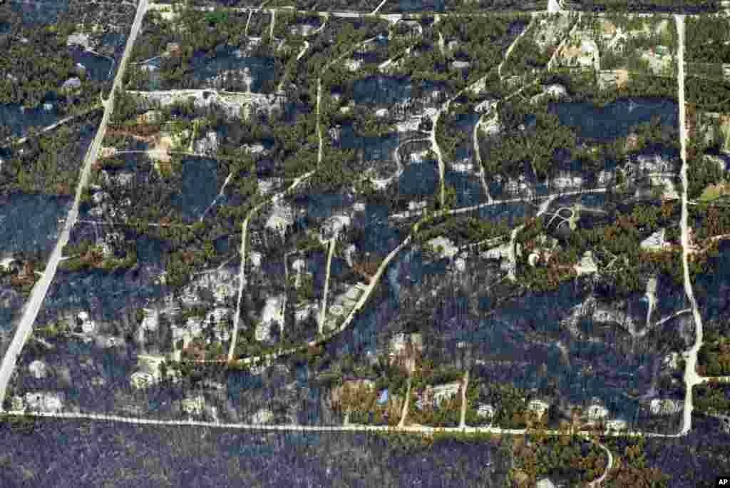 Burnt trees and destroyed homes are left in the wake of a wildfire in the densely wooded Black Forest area northeast of Colorado Springs, Colorado, June 13, 2013. 