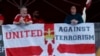 Manchester United fans hang a banner in reference to the terror attack in Manchester before a match.