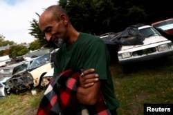 Omar Nabi, 43, originally from Afghanistan, takes a moment to recompose himself as he speaks about his late father, Haji-Daoud Nabi's love for cars at Haji-Daoud's property in Christchurch, New Zealand, March 31, 2019.