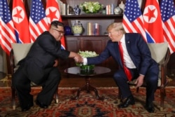 North Korea leader Kim Jong Un and U.S. President Donald Trump during their first meeting at the Capella resort on Sentosa Island Tuesday, June 12, 2018 in Singapore. (AP Photo/Evan Vucci)