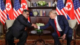 North Korea leader Kim Jong Un and U.S. President Donald Trump during their first meeting at the Capella resort on Sentosa Island Tuesday, June 12, 2018 in Singapore. (AP Photo/Evan Vucci)