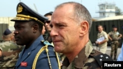 FILE - French General Christian Damay (R), commander of the EU Force in Congo, and General John Numbi (L), head of Congo's Airforce, inspect the EU Force base in Kinshasa.