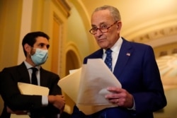 FILE - U.S. Senate Majority Leader Chuck Schumer (D-NY) returns to a press conference at the U.S. Capitol in Washington, Nov. 16, 2021.