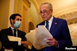 FILE - U.S. Senate Majority Leader Chuck Schumer (D-NY) returns to a press conference at the U.S. Capitol in Washington, Nov. 16, 2021.