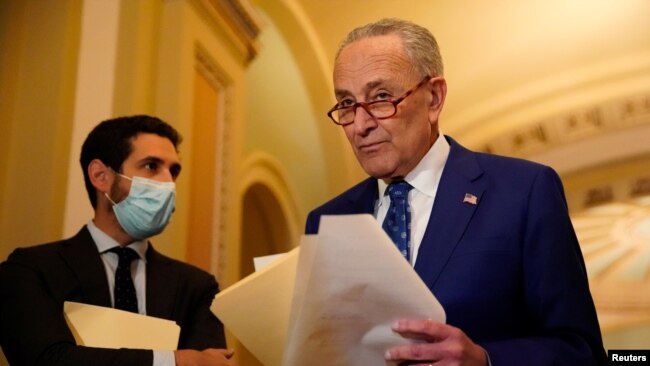 U.S. Senate Majority Leader Chuck Schumer returns to a press conference after speaking to an aide following the Senate Democrats weekly policy lunch at the U.S. Capitol in Washington, U.S., Nov. 16, 2021.