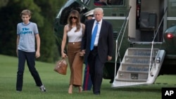 President Donald Trump, first lady Melania Trump, and their son and Barron Trump walk from Marine One across the South Lawn to the White House in Washington, June 11, 2017.