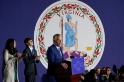 Democratic gubernatorial candidate Terry McAuliffe speaks in front of the flag of Virginia at an election night party in McLean, Virginia, Nov. 2, 2021. McAuliffe ended up losing to his Republican opponent Glenn Youngkin.