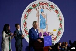 Democratic gubernatorial candidate Terry McAuliffe speaks in front of the flag of Virginia at an election night party in McLean, Virginia, Nov. 2, 2021. McAuliffe ended up losing to his Republican opponent Glenn Youngkin.