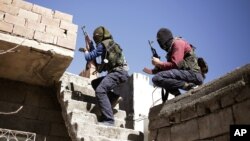 FILE - Militants from the Kurdistan Workers' Party, or PKK, run as they attack Turkish security forces in Nusaydin, Turkey, March 1, 2016.