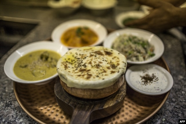 FILE - Biryani and other dishes are pictured at the Geet Restaurant on February 20, 2018 in Pretoria. (Photo by GULSHAN KHAN / AFP)