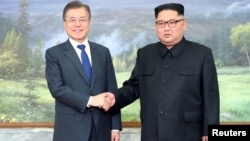 South Korean President Moon Jae-in shakes hands with North Korean leader Kim Jong Un during their summit at the truce village of Panmunjom, North Korea, May 26, 2018.