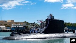 FILE - The submarine USS Illinois returns to Joint Base Pearl Harbor-Hickam from a deployment, Sept. 13, 2021. Australia decided to invest in U.S. nuclear-powered submarines and dump its contract with France to build diesel-electric submarines.