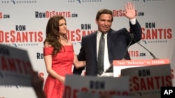 Florida Republican gubernatorial candidate Ron DeSantis, right, waves to supporters with his wife, Casey, at an election party after winning the Republican primary, Aug. 28, 2018, in Orlando, Florida.