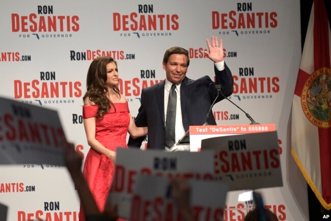 Florida Republican gubernatorial candidate Ron DeSantis, right, waves to supporters with his wife, Casey, at an election party after winning the Republican primary, Aug. 28, 2018, in Orlando, Florida.
