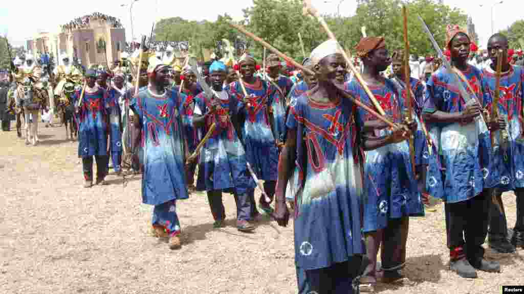 Hunters take part in a parade as they pay homage to Emir of Kano Alhaji Ado Bayero during an event marking his 50th year on the throne.