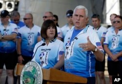 FILE - Indiana Gov. Mike Pence speaks as his wife Karen, looks on at the opening ceremony for the Cops Cycling for Survivors fundraising bike ride in Indianapolis, July 11, 2016.