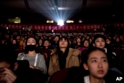 Audience members watch a screening of the state-backed documentary "Amazing China" at the Beijing Film Academy in Beijing, China, March 22, 2018.