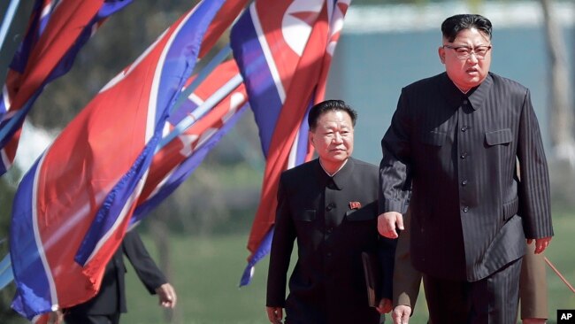 North Korean leader Kim Jong Un (right) and Choe Ryong Hae, vice-chairman of the central committee of the Workers' Party, arrive for the official opening of the Ryomyong residential area, April 13, 2017, in Pyongyang, North Korea.