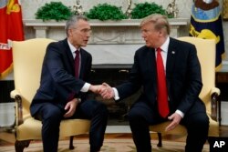 President Donald Trump shakes hands with with NATO Secretary General Jens Stoltenberg during a meeting in the Oval Office of the White House, April 2, 2019 in Washington.