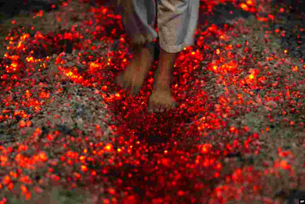A Shi'ite Muslim walks on fire at a ceremony during the Ashura festival at a mosque in central Yangon December 16. (Soe Zeya Tun/Reuters)