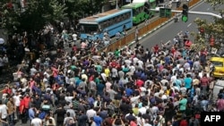 Iranian protesters shout slogans during a demonstration in central Tehran on June 25, 2018. Traders in the Iranian capital's Grand Bazaar held a rare protest strike against the collapse of the rial on the foreign exchange market.