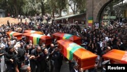 Pallbearers carry the coffins of victims of the Ethiopian Airline Flight ET 302 plane crash, during the burial ceremony at the Holy Trinity Cathedral Orthodox church in Addis Ababa, Ethiopia, March 17, 2019. 