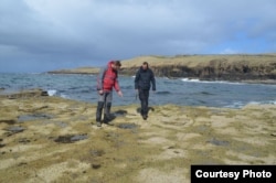 Paleontologist Steve Brusatte, right, and colleague Tom Challands on the Isle of Skye in Scotland where the massive dinosaur tracks were found. (Credit. Mark Wilkinson, University of Edinburgh)