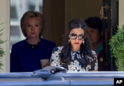 FILE - Top Clinton aide Huma Abedin walks ahead of Democratic presidential candidate Hillary Clinton at Clinton's home in Washington, D.C., June 10, 2016.