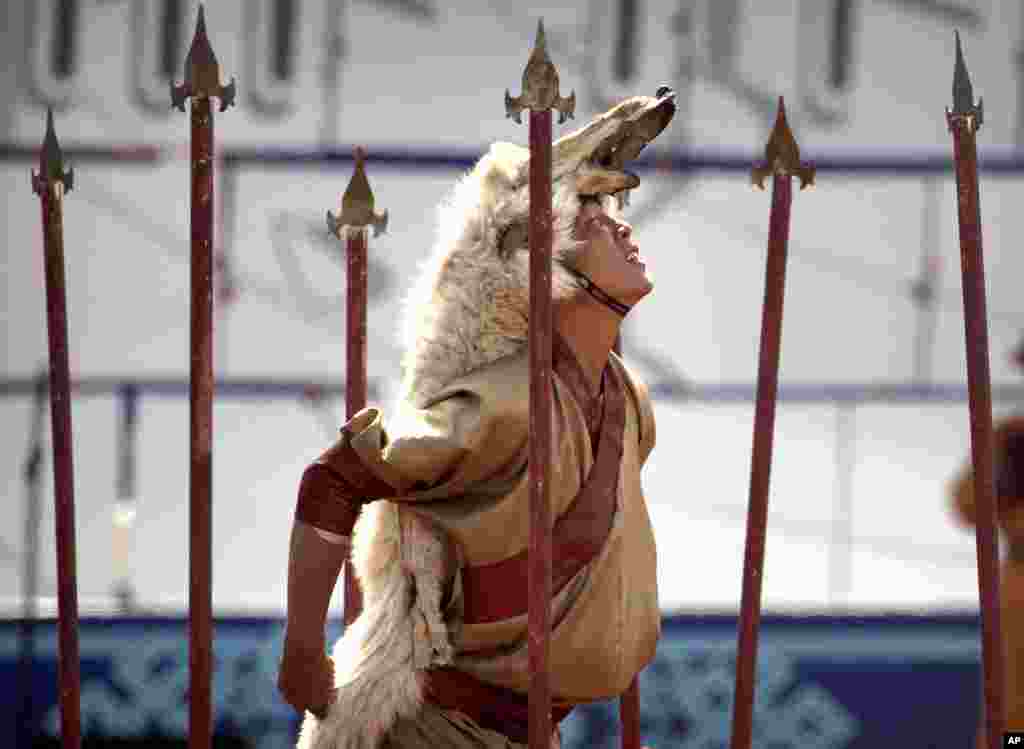 A performer wearing a wolfskin strikes a pose during the Naadam Festival in Ulaanbaatar, Mongolia.&nbsp;Mongolians celebrate the anniversary of Genghis Khan&#39;s march to world conquest on July 11, with the annual Naadam sports festival featuring traditional Mongolian events, including wrestling, archery, and horse racing.&nbsp;