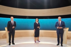 From left, Chancellor candidates Olaf Scholz (SPD), Annalena Baerbock (Green Party) and Armin Laschet (CDU) stand in the TV studio in Berlin, Sept. 12, 2021.