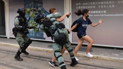 Cảnh sát truy đuổi hai người biểu tình đeo khẩu trang ở khu Trung Hoàn của Hong Kong, một ngày sau khi lãnh đạo của thành phố ban hành lệnh cấm đeo khẩu trang để ứng phó với các cuộc biểu tình ngày càng bạo lực, ngày 5 tháng 10, 2019.