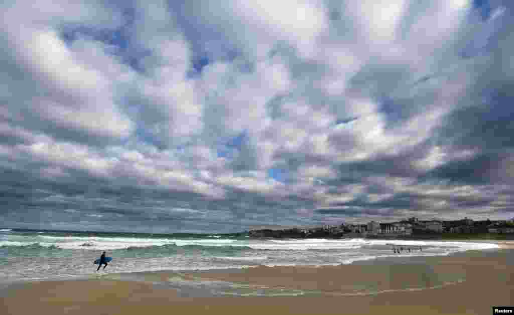 A man leaves the water after a surf session at Bondi Beach in Sydney, Australia.