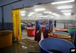 A government raid empties a shrimp shed in Samut Sakhon, Thailand, Nov. 9, 2015. Modern-day slavery often is considered an acceptable business practice in the country's seafood export capital.