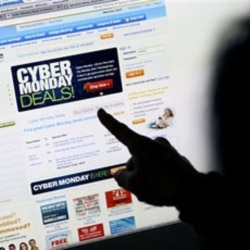 A woman from California points to a Cyber Monday advertisement on her computer. The Monday after Thanksgiving is a big day for Internet shopping. Sales online have only grown since the day got its name in 2005