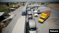 在墨西哥新拉雷多的世贸桥上，卡车排着长队等待边境海关检查，准备进入美国。（资料照片：2020年6月30日）