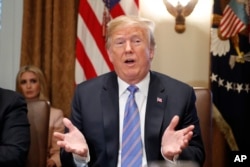 President Donald Trump speaks during his meeting with members of his cabinet in Cabinet Room of the White House in Washington, July 18, 2018.