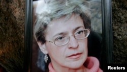 Mourners light candles next to a portrait of Russian journalist Anna Politkovskaya during a rally in St. Petersburg, Russia on October 8, 2006. She was assassinated on the previous day, in the lift of her apartment building. REUTERS/Alexander Demianchuk 