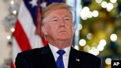 President Donald Trump listens people speak in support of Republican tax policy reform, during an event in the Grand Foyer of the White House, Dec. 13, 2017, in Washington.