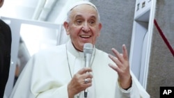 Pope Francis talks to journalists during a press conference en route to Italy from the United States, Sept. 28, 2015. 