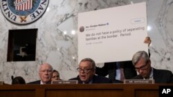 Sen. Dick Durbin, D-Ill., center, flanked by Sen. Patrick Leahy, D-Vt., left, and Sen. Sheldon Whitehouse, D-R.I., makes an opening statement as the Senate Judiciary Committee holds a hearing on the Trump administration's policies on immigration enforcement and family reunification efforts, on Capitol Hill in Washington, July 31, 2018. 