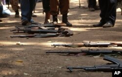 FILE - Guns that belonged to child soldiers lie on the ground at a release ceremony, where they laid down their weapons and traded in their uniforms to return to "normal life", in Yambio, South Sudan, Feb. 7, 2018.