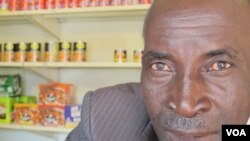 John Stheole has owned his spaza shop for more than a ten years in Dube Village, Soweto, South Africa. (Photo Gillian Parker for VOA)